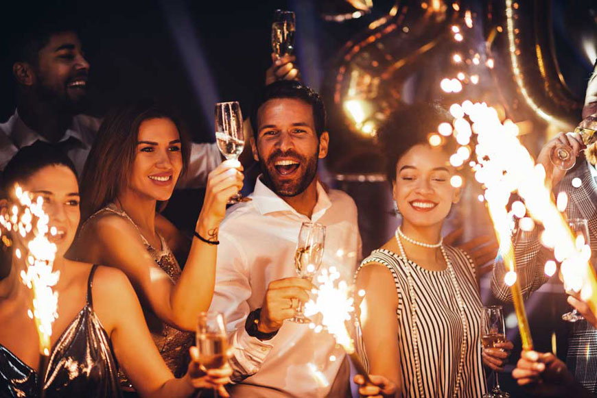 Friends holding sparklers at a New Year’s Eve party in Scottsdale